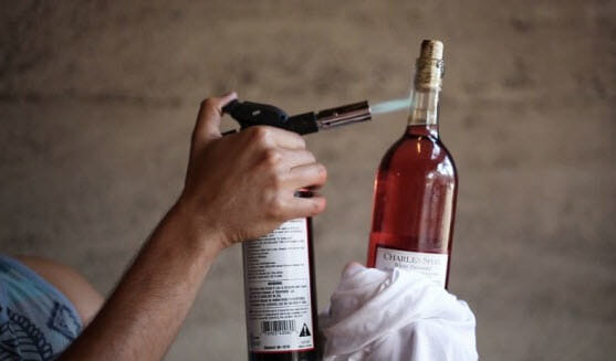 Open wine with a lighter or kitchen torch
