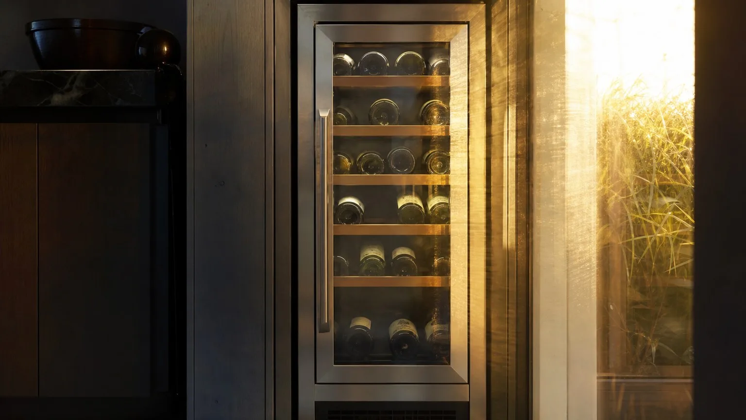 Wine cooler placed near a sunny window receiving direct sunlight, illustrating a placement mistake